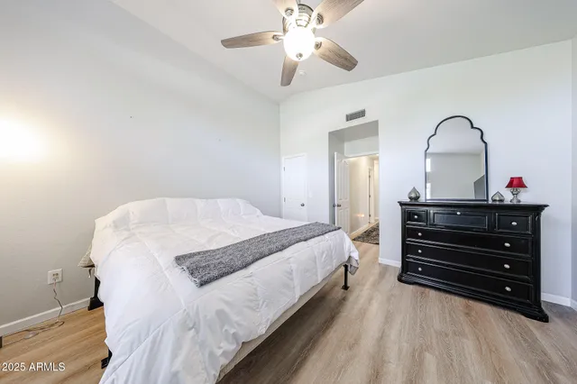 a bedroom with a bed and a chandelier
