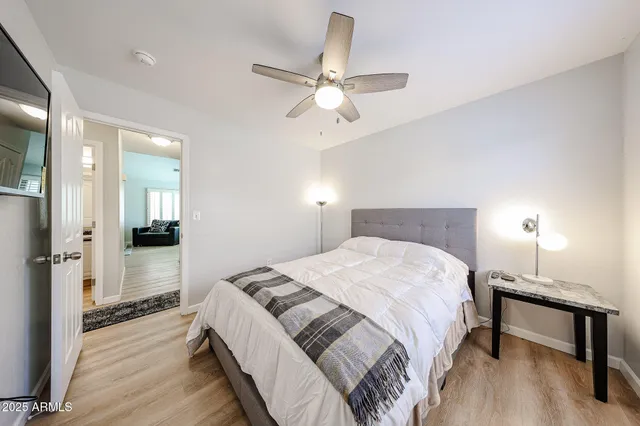 a bedroom with a bed and a chandelier