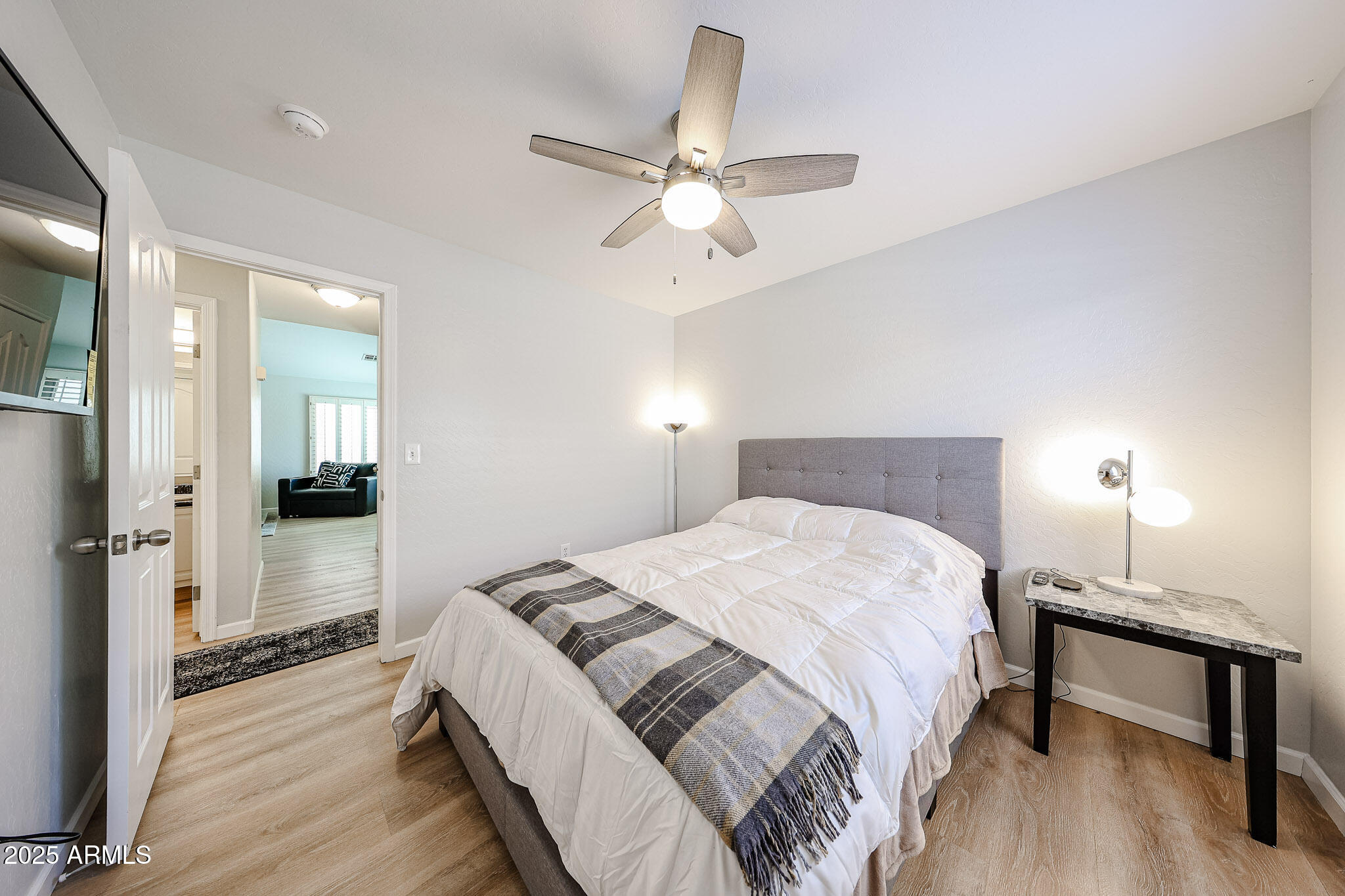 20007 North 20th Way Phoenix, AZ 85024 - Photo 18 of 30 a bedroom with a bed and a chandelier