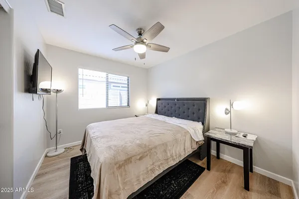 a bedroom with a bed and a chandelier