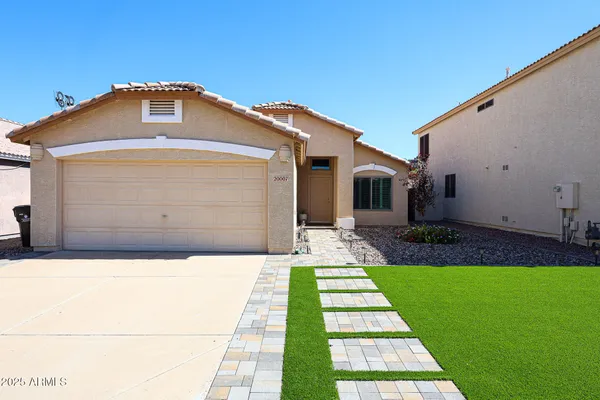 a front view of a house with a yard