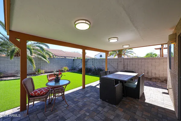 an outdoor sitting area with furniture and garden view