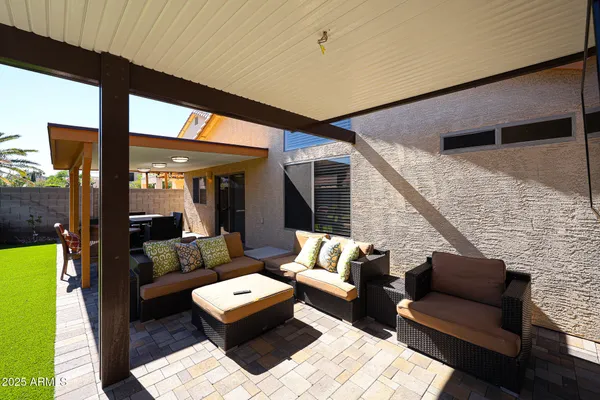 a outdoor living room with furniture and large window