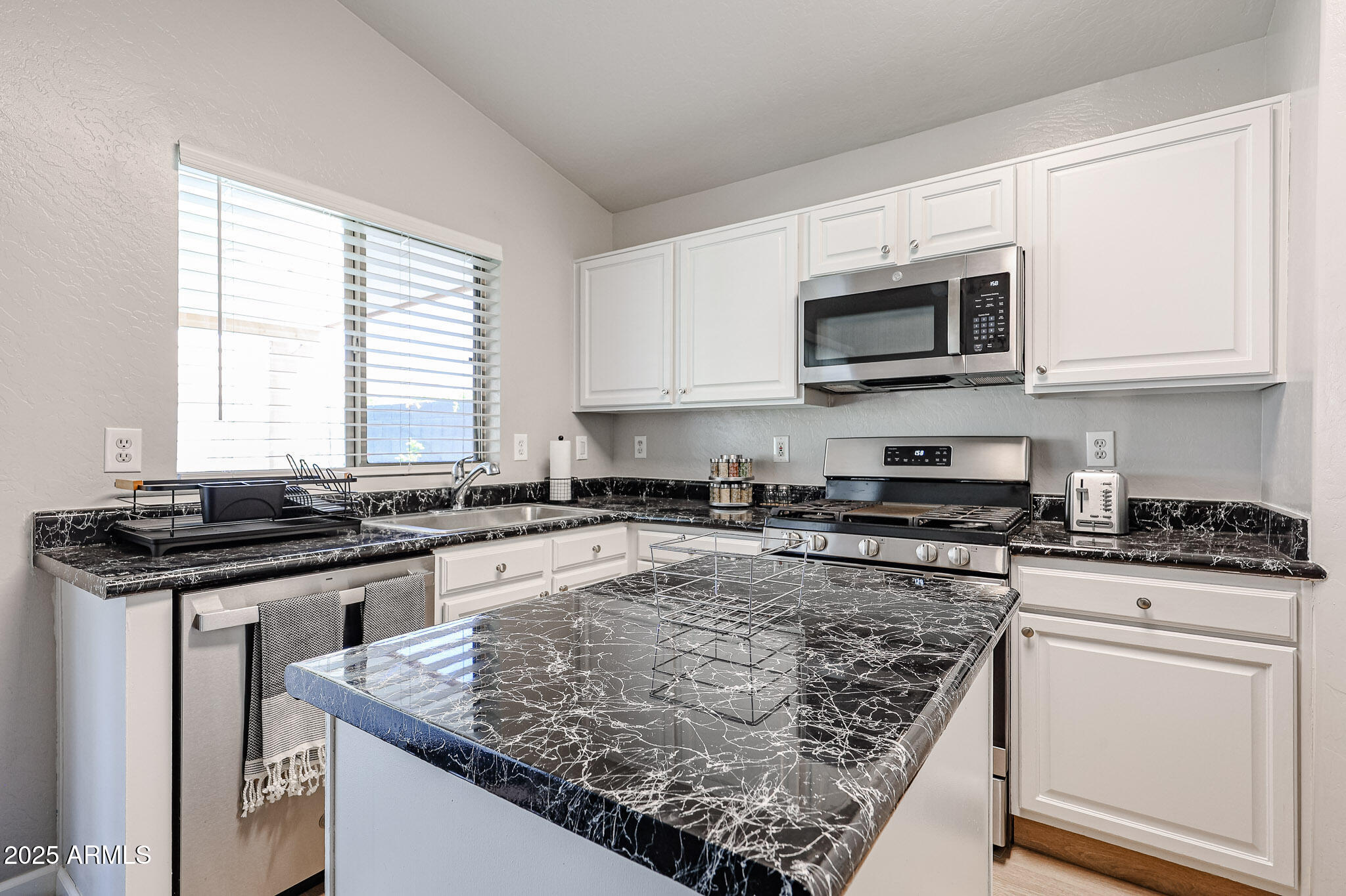 20007 North 20th Way Phoenix, AZ 85024 - Photo 6 of 30 a kitchen with stainless steel appliances granite countertop a stove and a sink