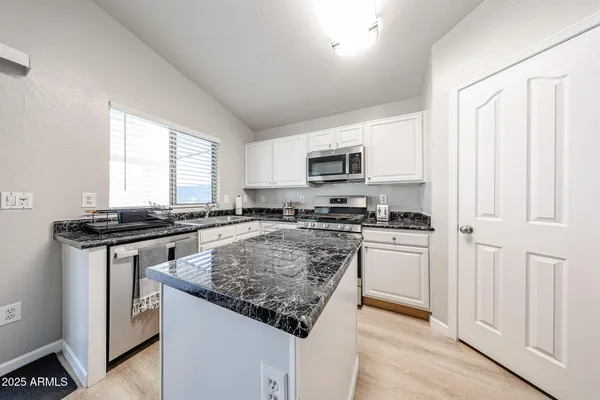 a kitchen with stainless steel appliances a sink stove and microwave