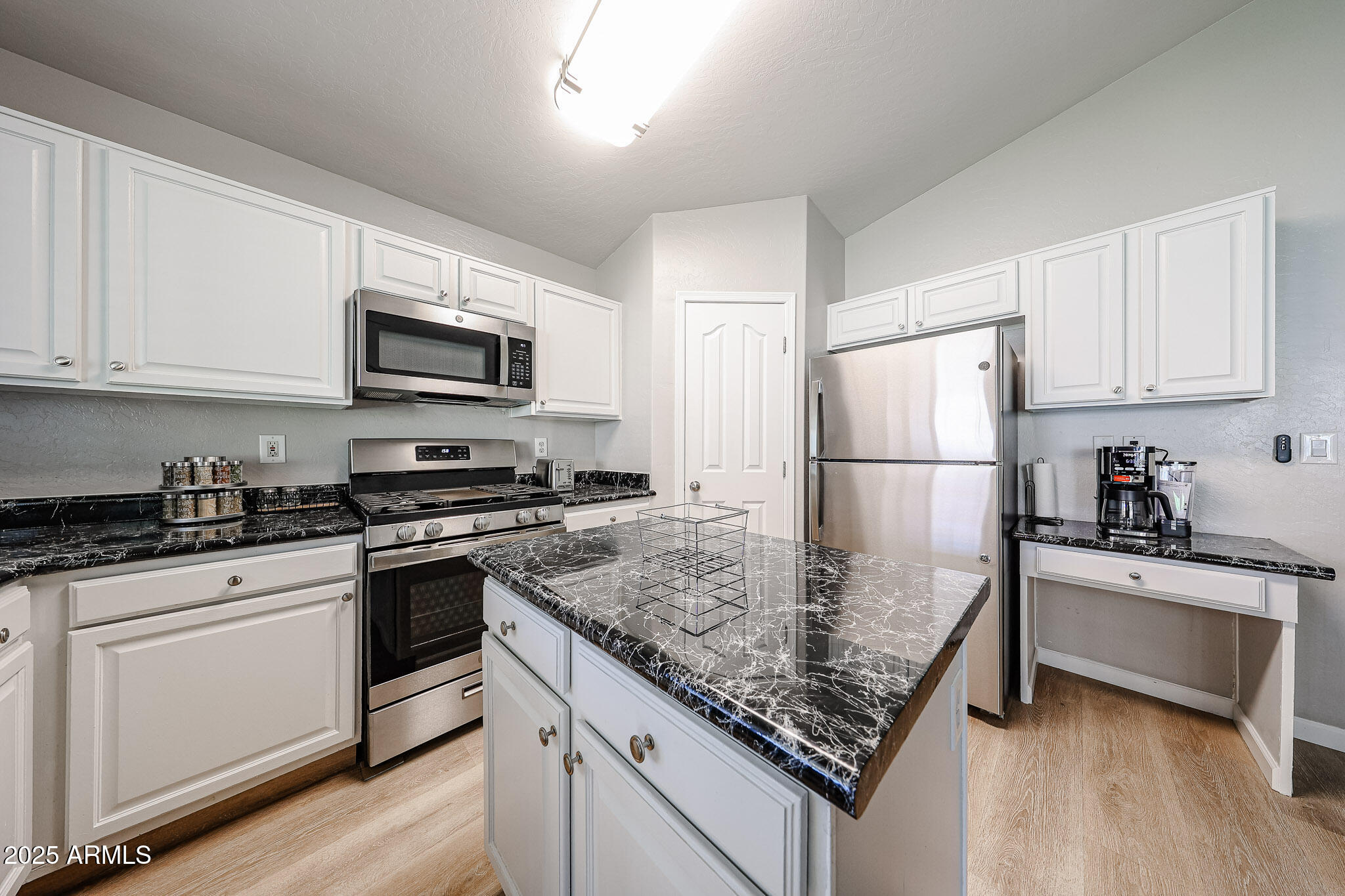 20007 North 20th Way Phoenix, AZ 85024 - Photo 8 of 30 a kitchen with kitchen island a sink stainless steel appliances and counter space