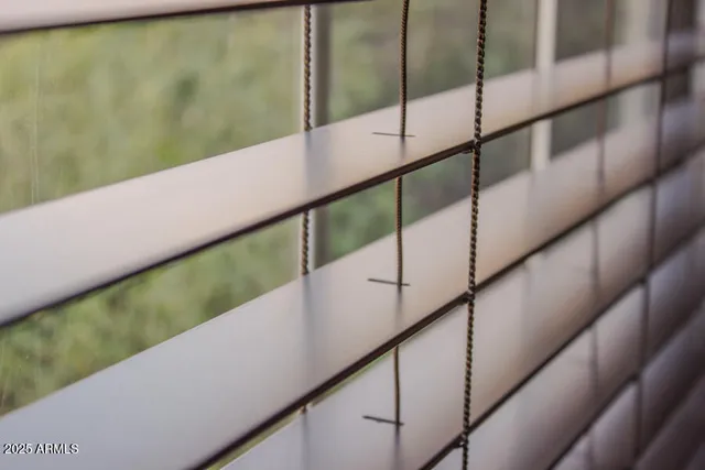 a view of a hallway with wooden cabinet and a living room