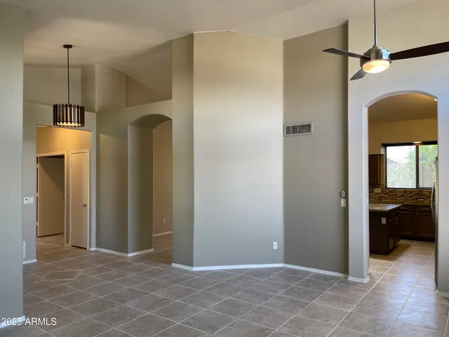 a view of an empty room with a fireplace and a window