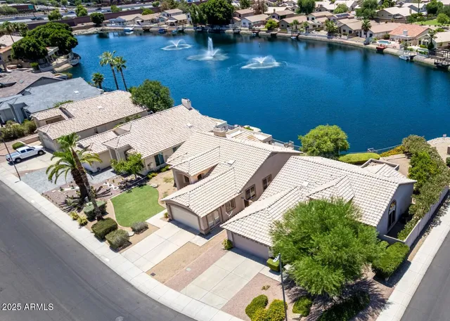 an aerial view of a house with a lake view