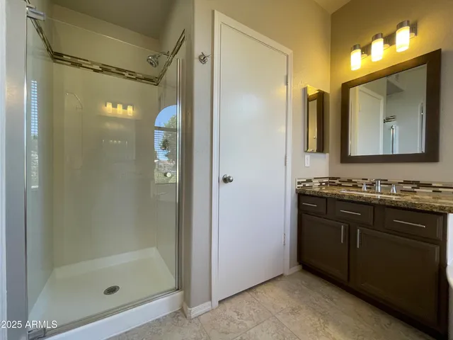 a view of a bathroom with a sink and a mirror