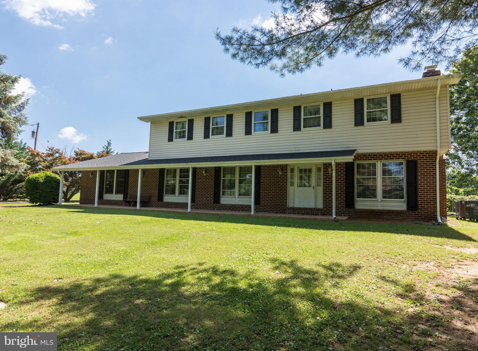 7227 Morgan Road Woodbine, MD 21797 - Photo 2 of 29 a front view of a house with a garden