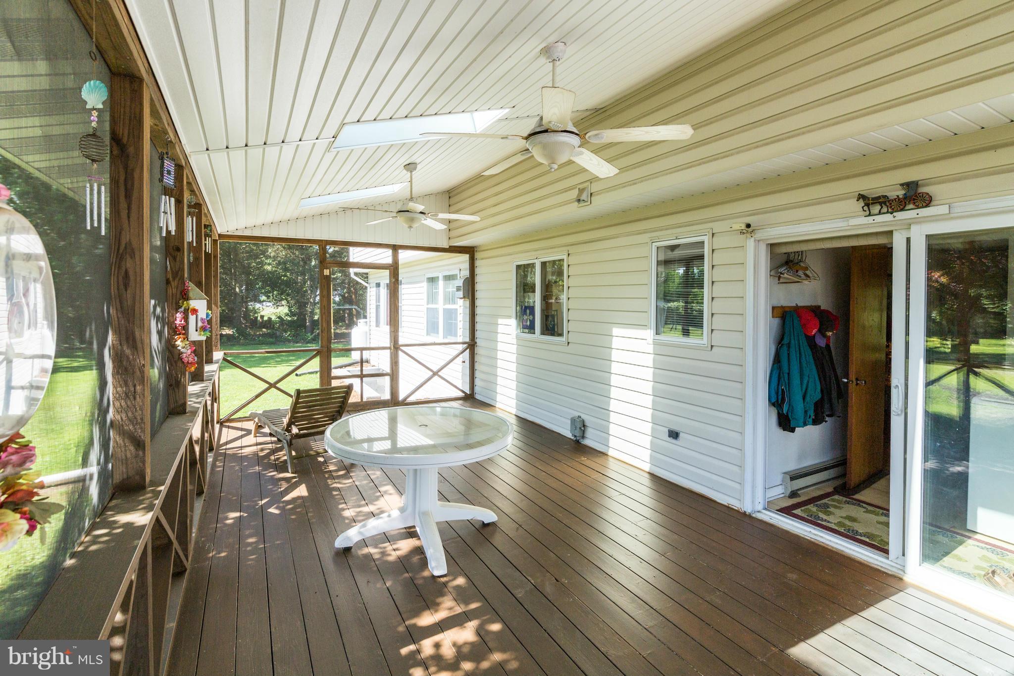 7227 Morgan Road Woodbine, MD 21797 - Photo 16 of 29 a view of a porch with wooden floor and fence