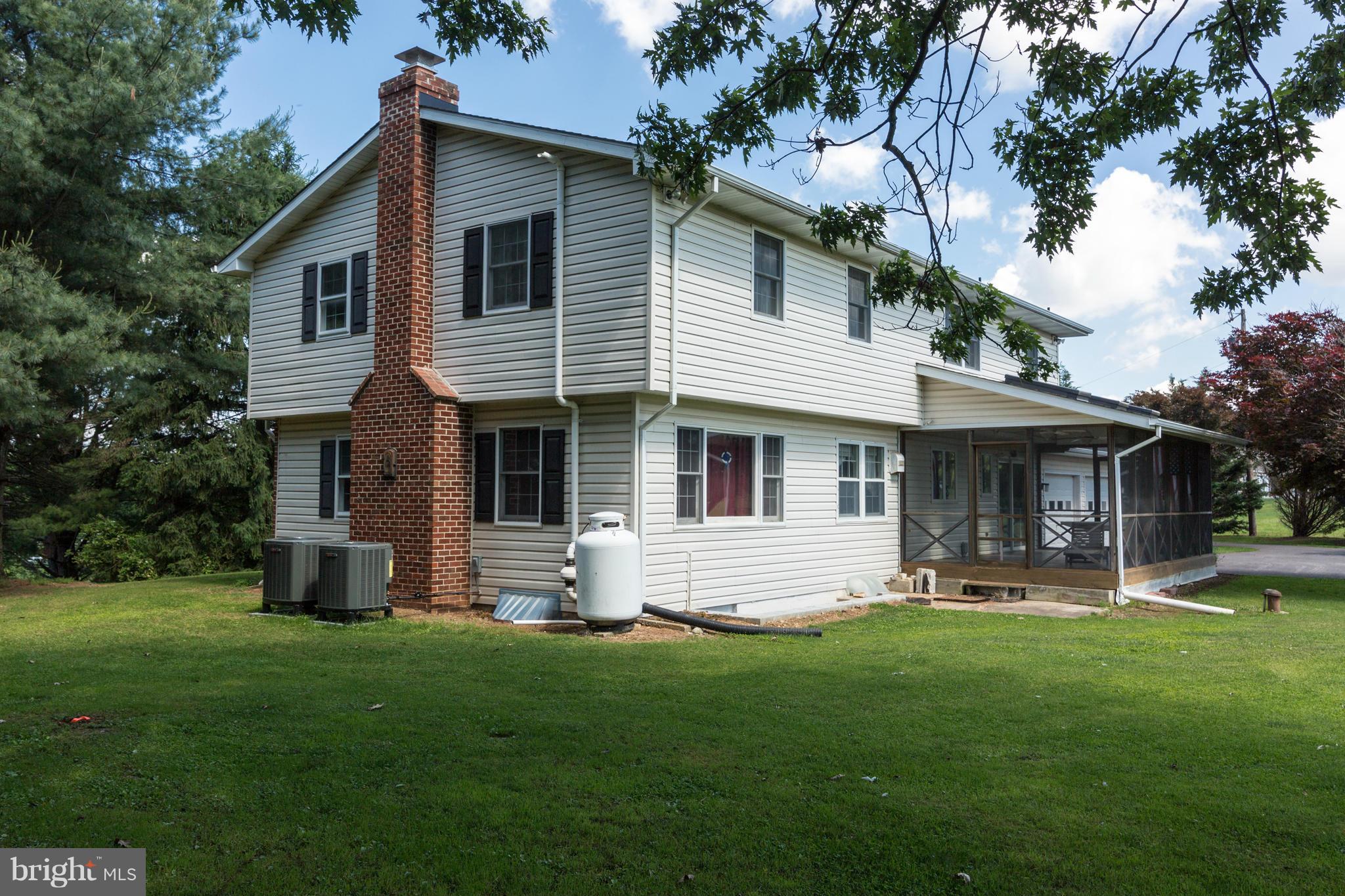 7227 Morgan Road Woodbine, MD 21797 - Photo 23 of 29 a front view of house with yard and outdoor seating