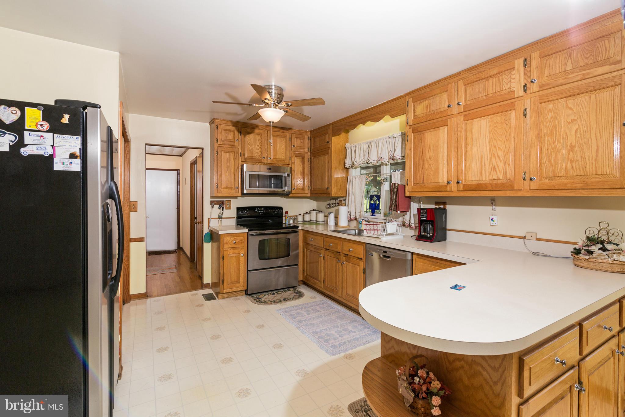 7227 Morgan Road Woodbine, MD 21797 - Photo 5 of 29 a kitchen with a sink a refrigerator and a stove top oven