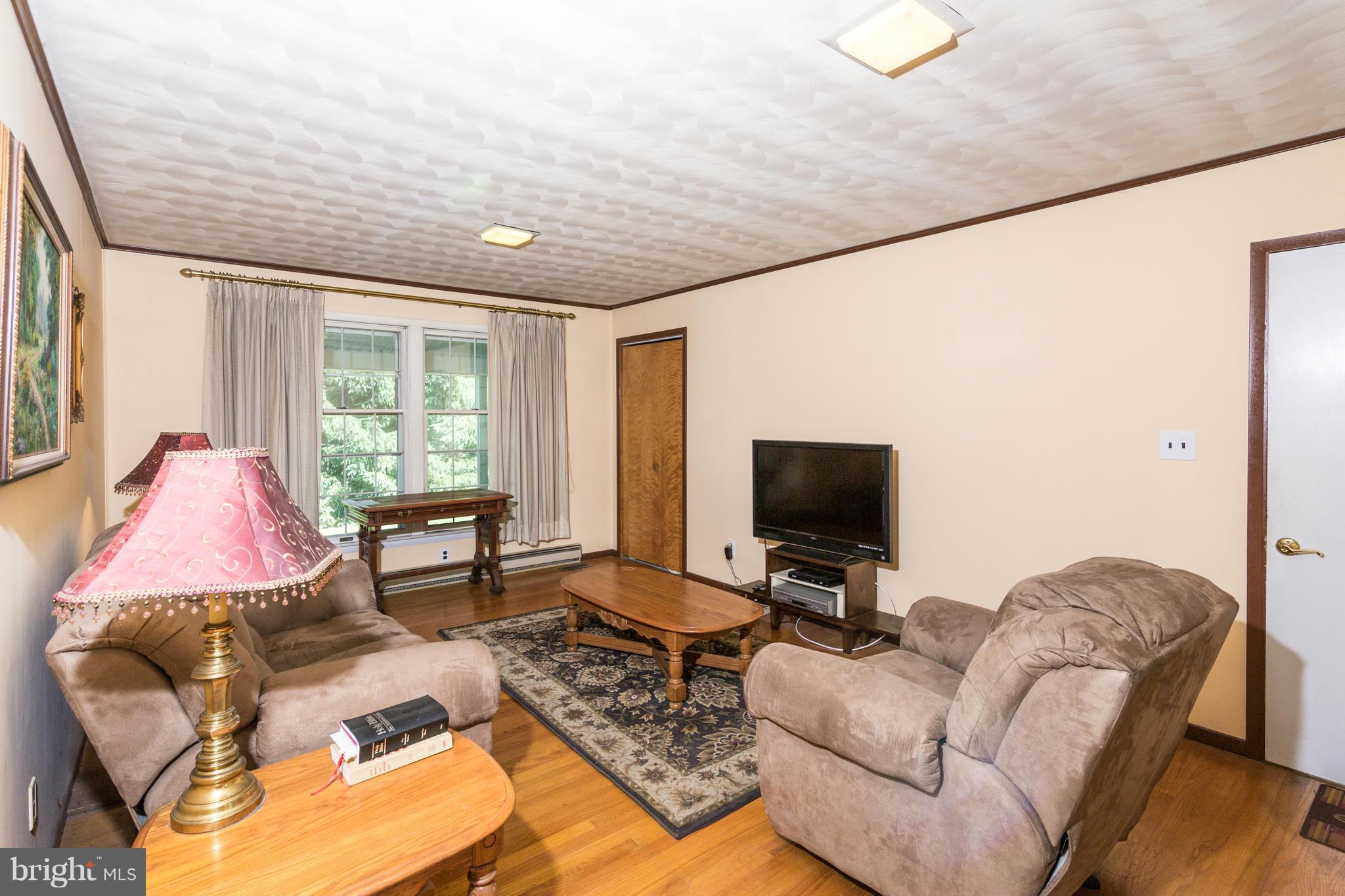 7227 Morgan Road Woodbine, MD 21797 - Photo 8 of 29 a living room with furniture and a flat screen tv