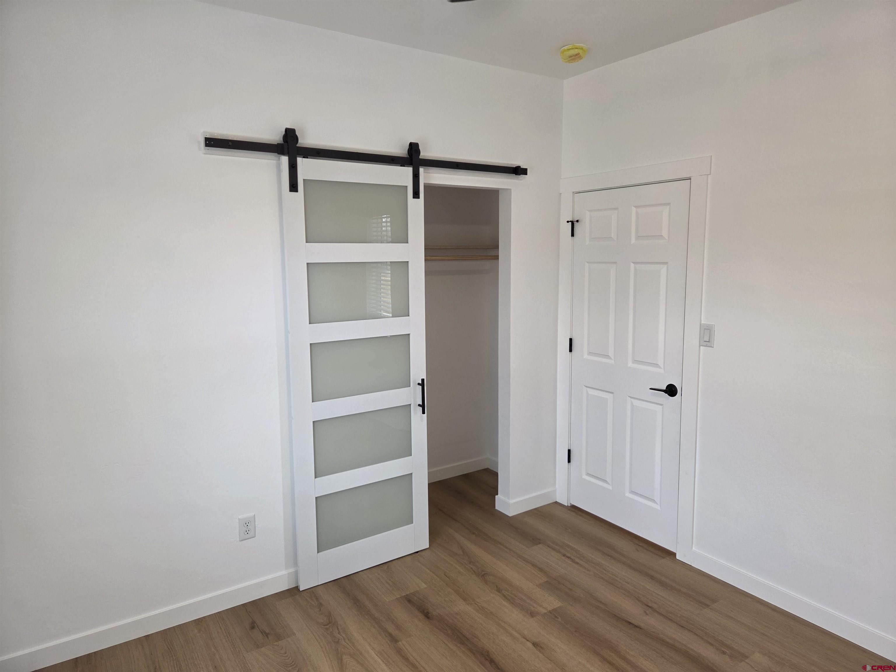1456 Acoma Street Cortez, CO 81321 - Photo 18 of 26 a view of an empty room with wooden floor