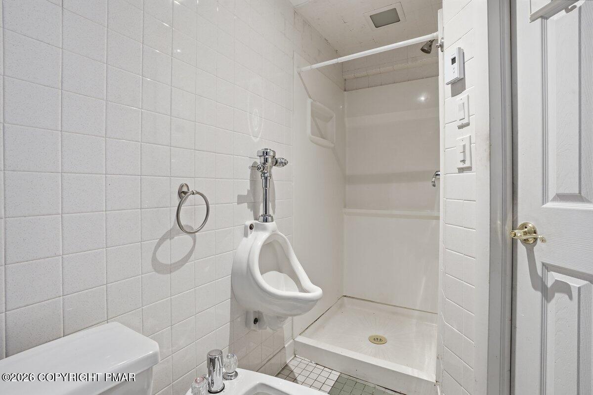 3116 Woodland Court Bushkill, PA 18324 - Photo 26 of 72 a bathroom with a glass shower door