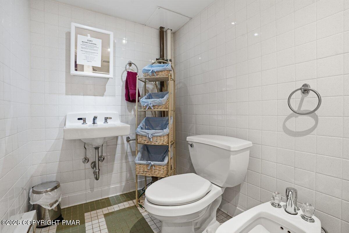 3116 Woodland Court Bushkill, PA 18324 - Photo 27 of 72 a bathroom with a toilet sink and mirror