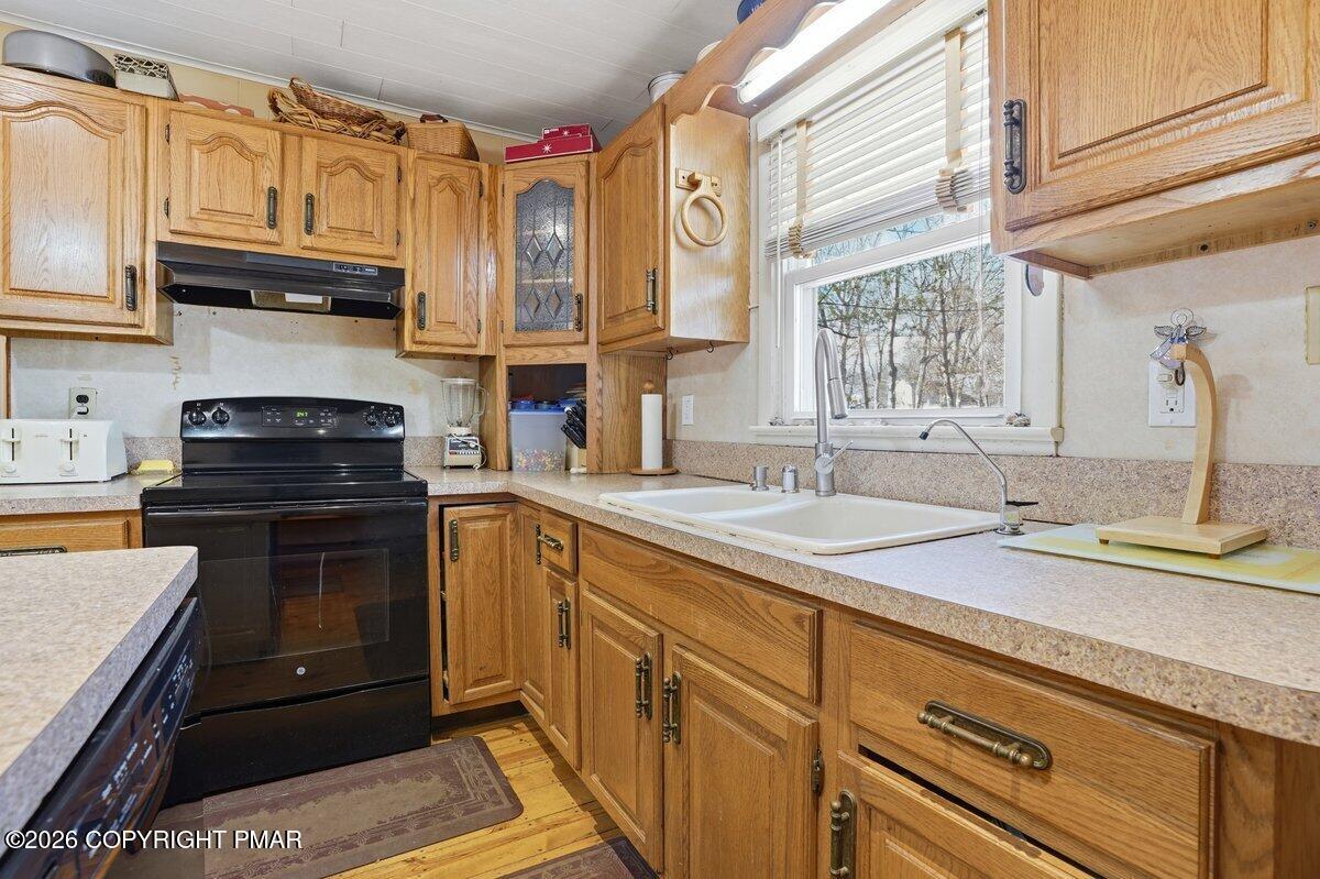 3116 Woodland Court Bushkill, PA 18324 - Photo 30 of 72 a kitchen with stainless steel appliances granite countertop a sink and cabinets