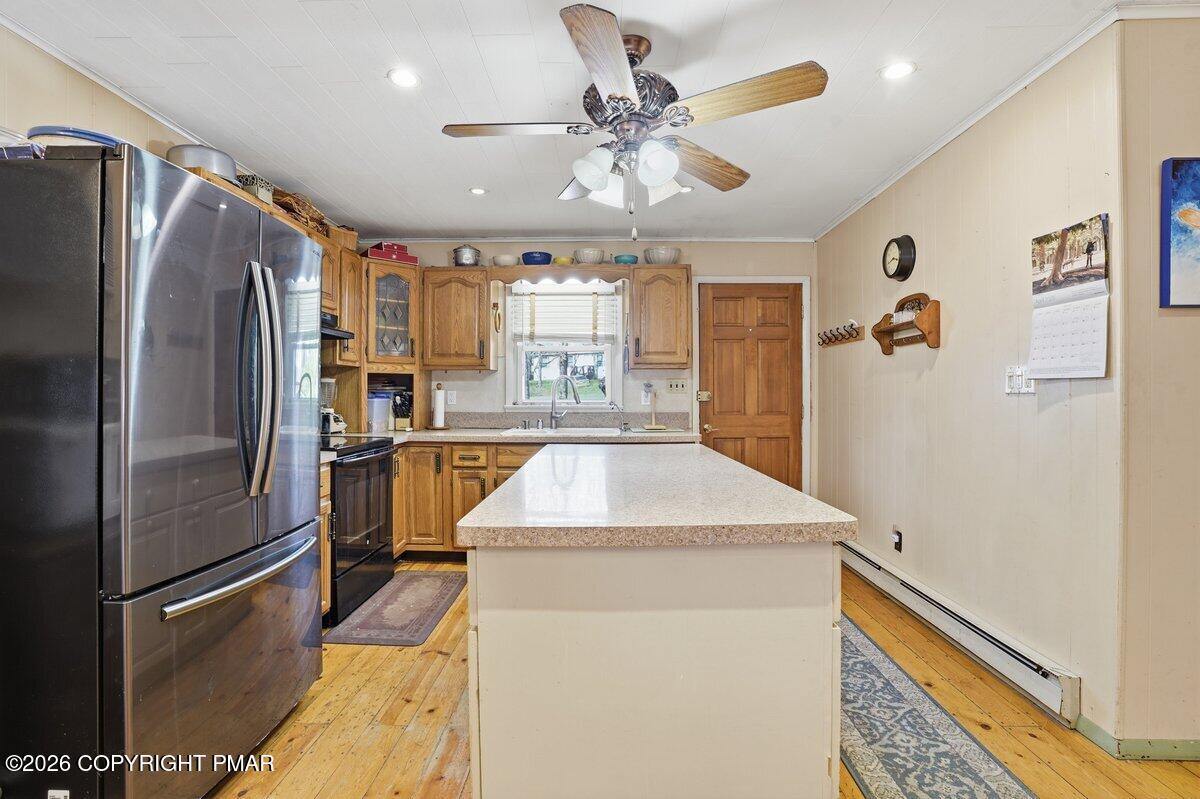 3116 Woodland Court Bushkill, PA 18324 - Photo 3 of 72 a kitchen with kitchen island a counter top space a refrigerator and a sink