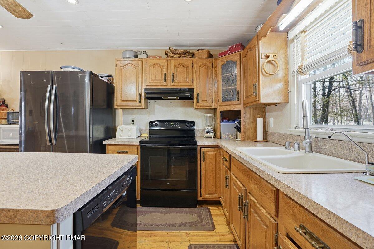 3116 Woodland Court Bushkill, PA 18324 - Photo 31 of 72 a kitchen with stainless steel appliances a sink stove refrigerator and a window