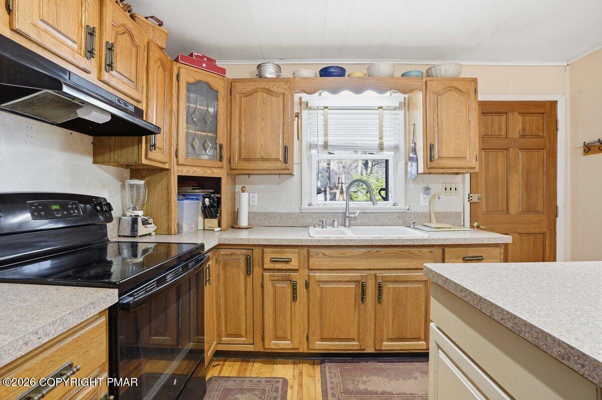 3116 Woodland Court Bushkill, PA 18324 - Photo 34 of 72 a kitchen with a sink stove and cabinets