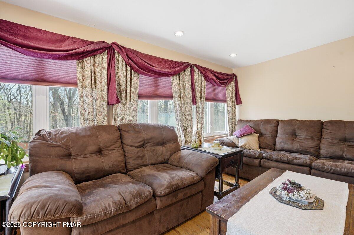 3116 Woodland Court Bushkill, PA 18324 - Photo 38 of 72 a living room with furniture a large window and a potted plant