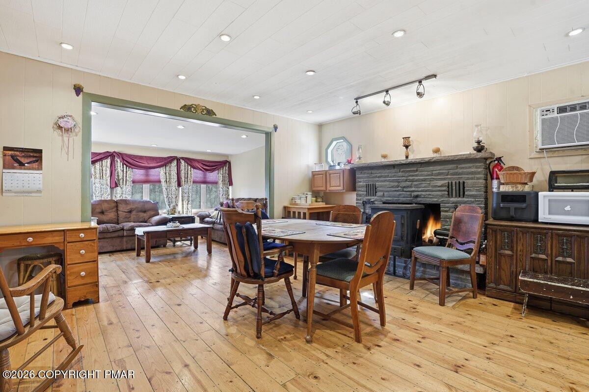 3116 Woodland Court Bushkill, PA 18324 - Photo 4 of 72 a dining room with furniture a rug and wooden floor