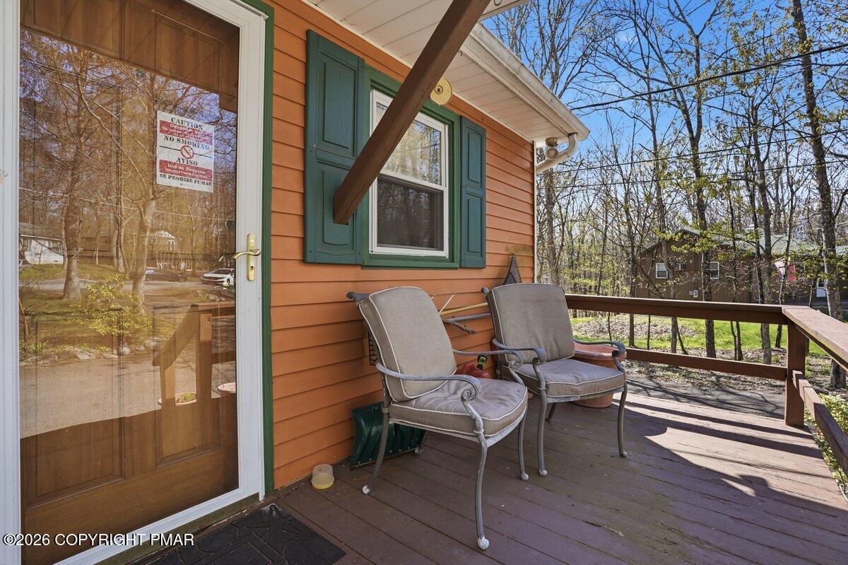 3116 Woodland Court Bushkill, PA 18324 - Photo 67 of 72 a balcony with wooden floor and outdoor seating
