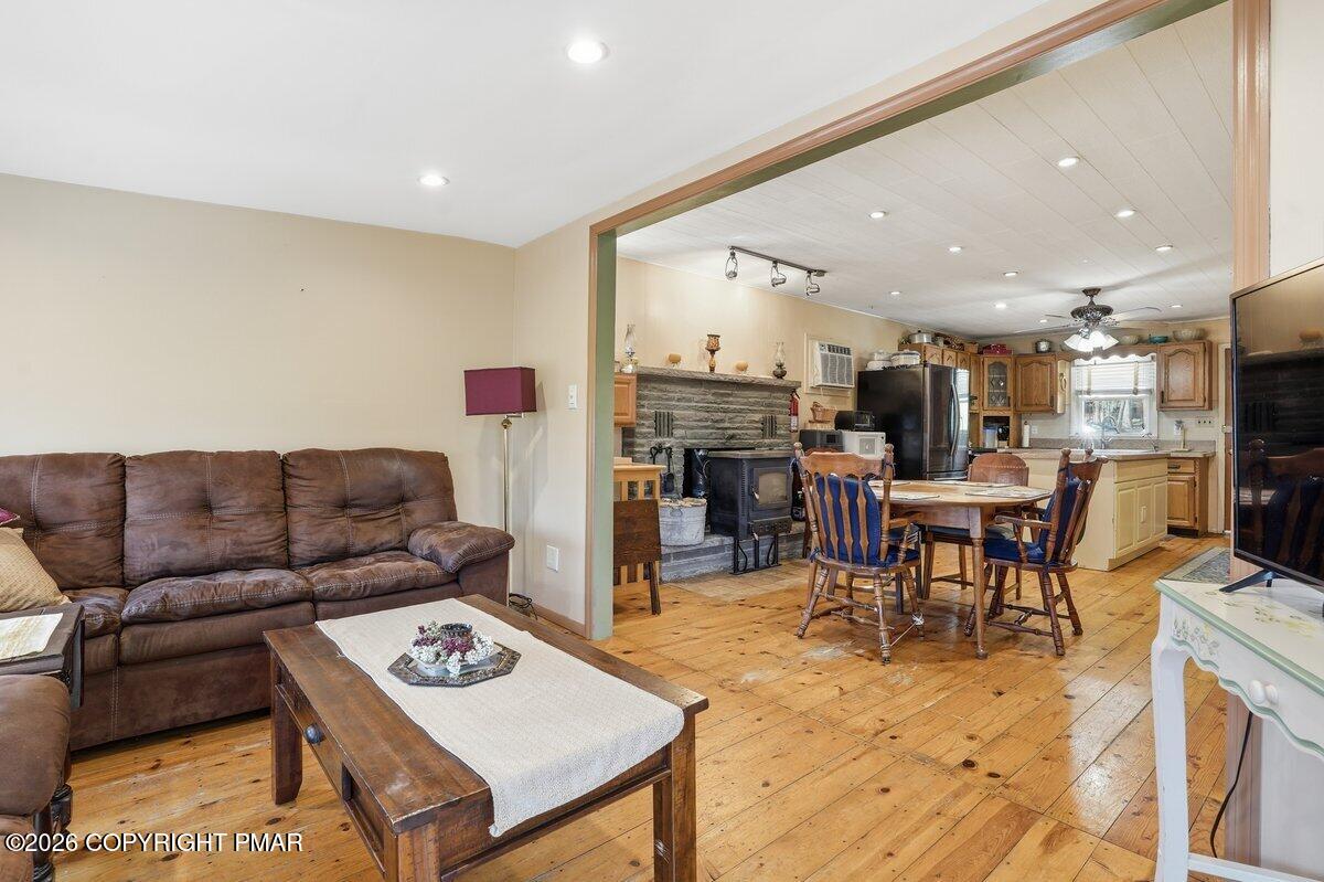 3116 Woodland Court Bushkill, PA 18324 - Photo 7 of 72 a living room with furniture a flat screen tv and kitchen view