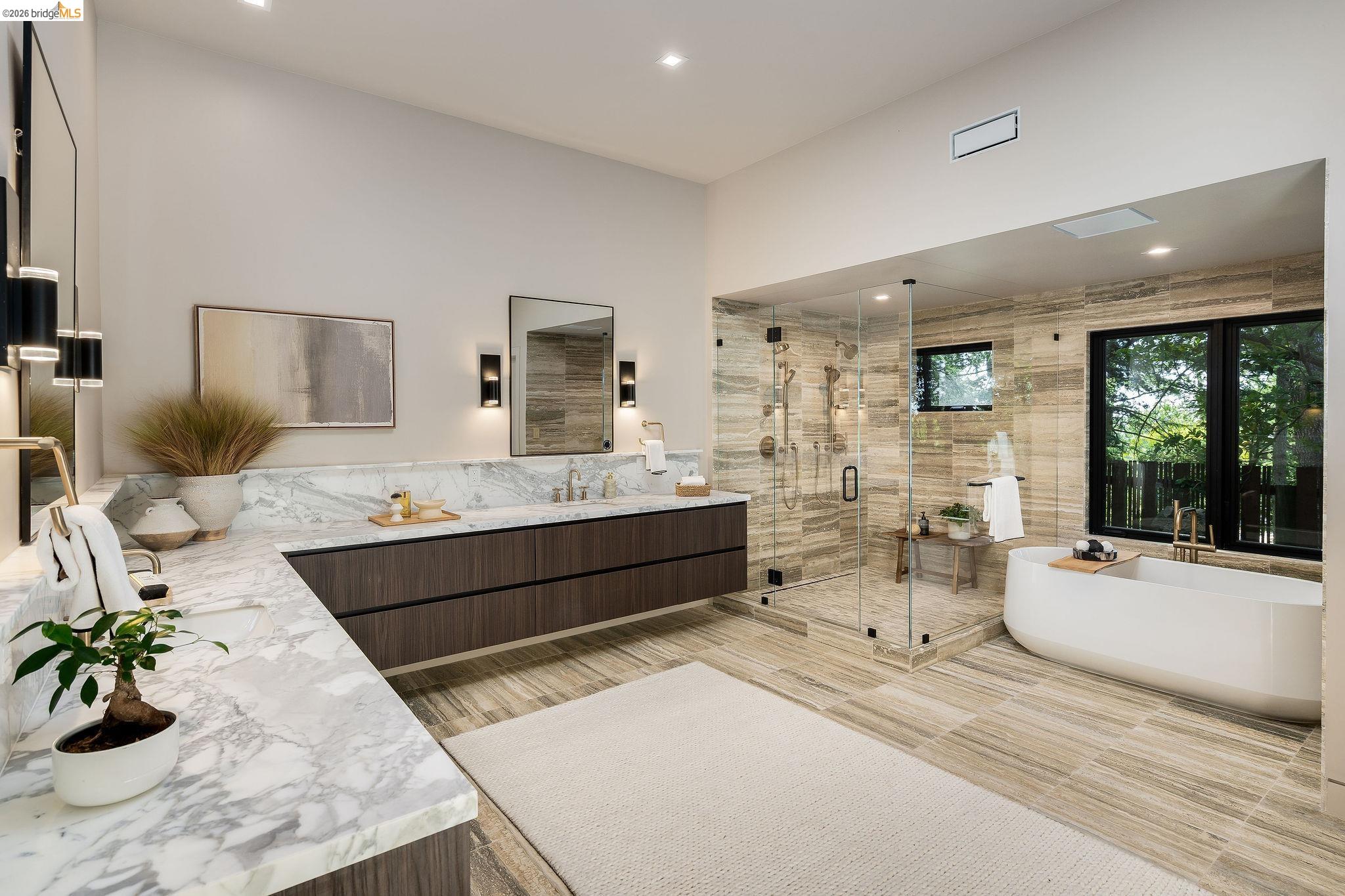 5645 Bacon Road Oakland, CA 94619 - Photo 67 of 94 Spacious bathroom featuring a dual vanity with a stone countertop, a glass-enclosed shower, a freestanding soaking tub, and large format tile flooring