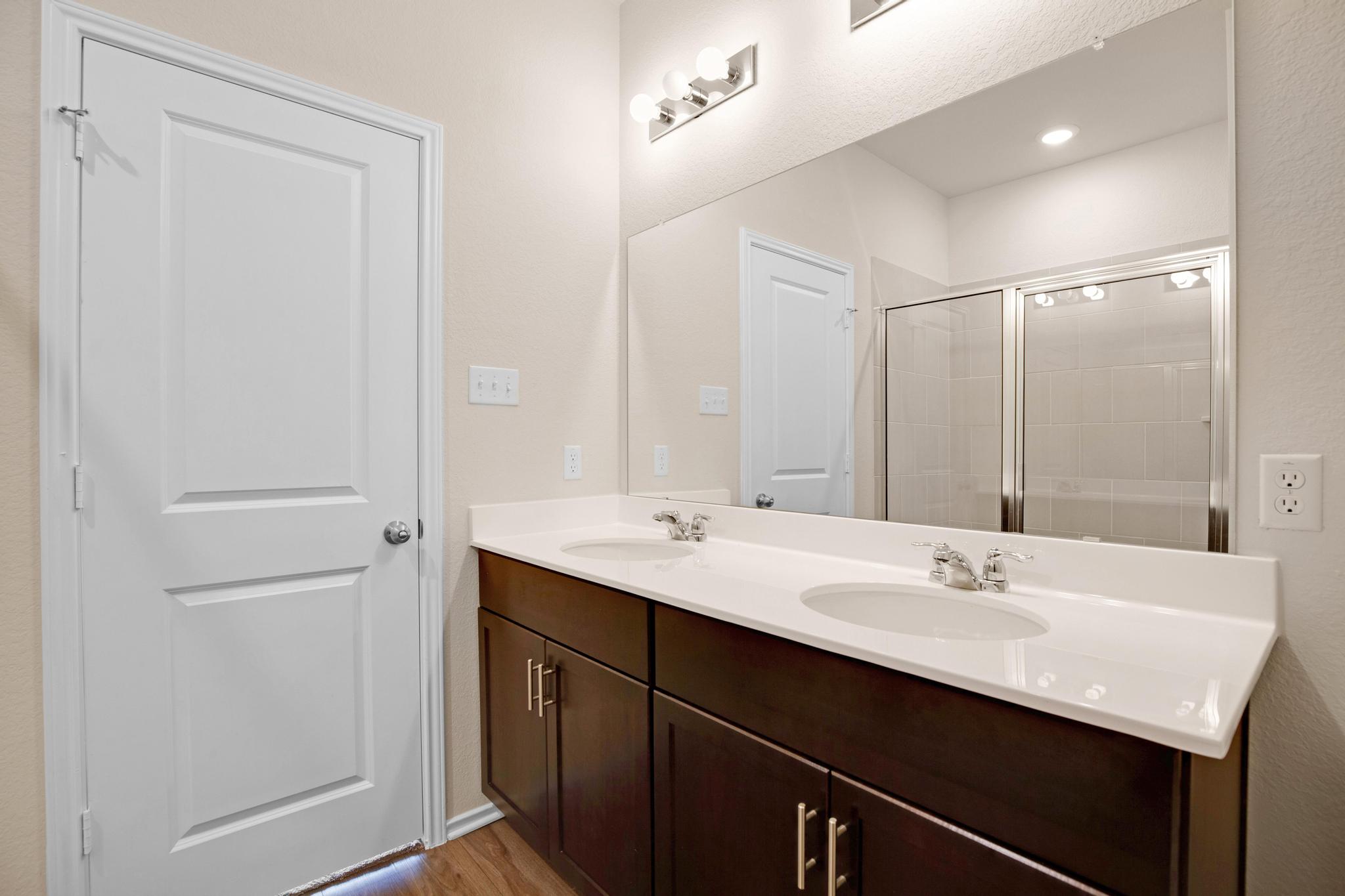 200 Janice Road Taylor, TX 76574 - Photo 14 of 25 A well-appointed bathroom features a double vanity and sleek modern fixtures.