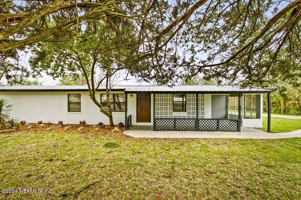 8264 Devoe Street Jacksonville, FL 32220 - Photo 1 of 24 a front view of a house with garden