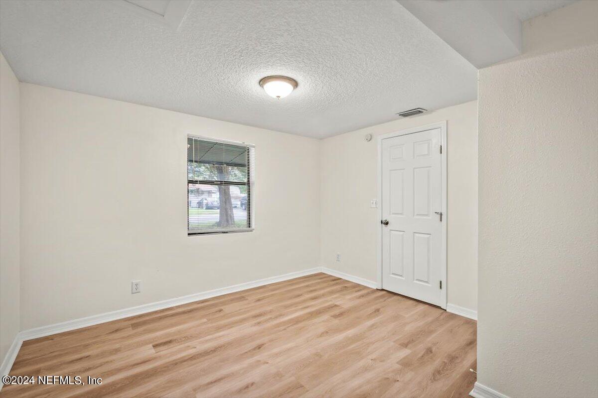 8264 Devoe Street Jacksonville, FL 32220 - Photo 11 of 24 a view of empty room with wooden floor