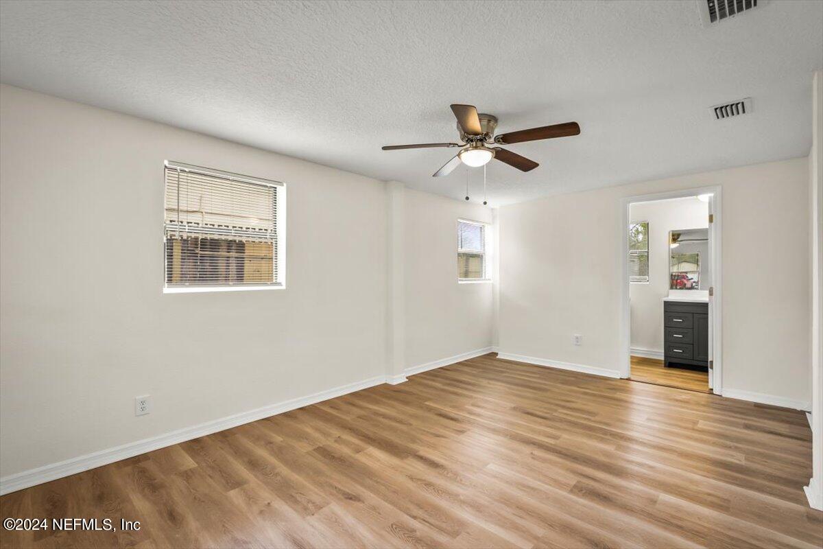 8264 Devoe Street Jacksonville, FL 32220 - Photo 16 of 24 a view of empty room with wooden floor and fan