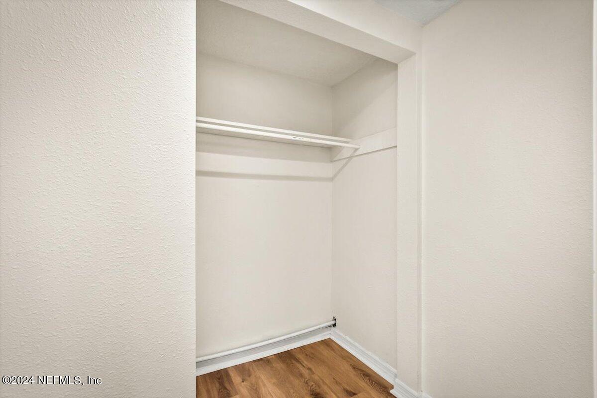 8264 Devoe Street Jacksonville, FL 32220 - Photo 17 of 24 a view of walk in closet with wooden floor