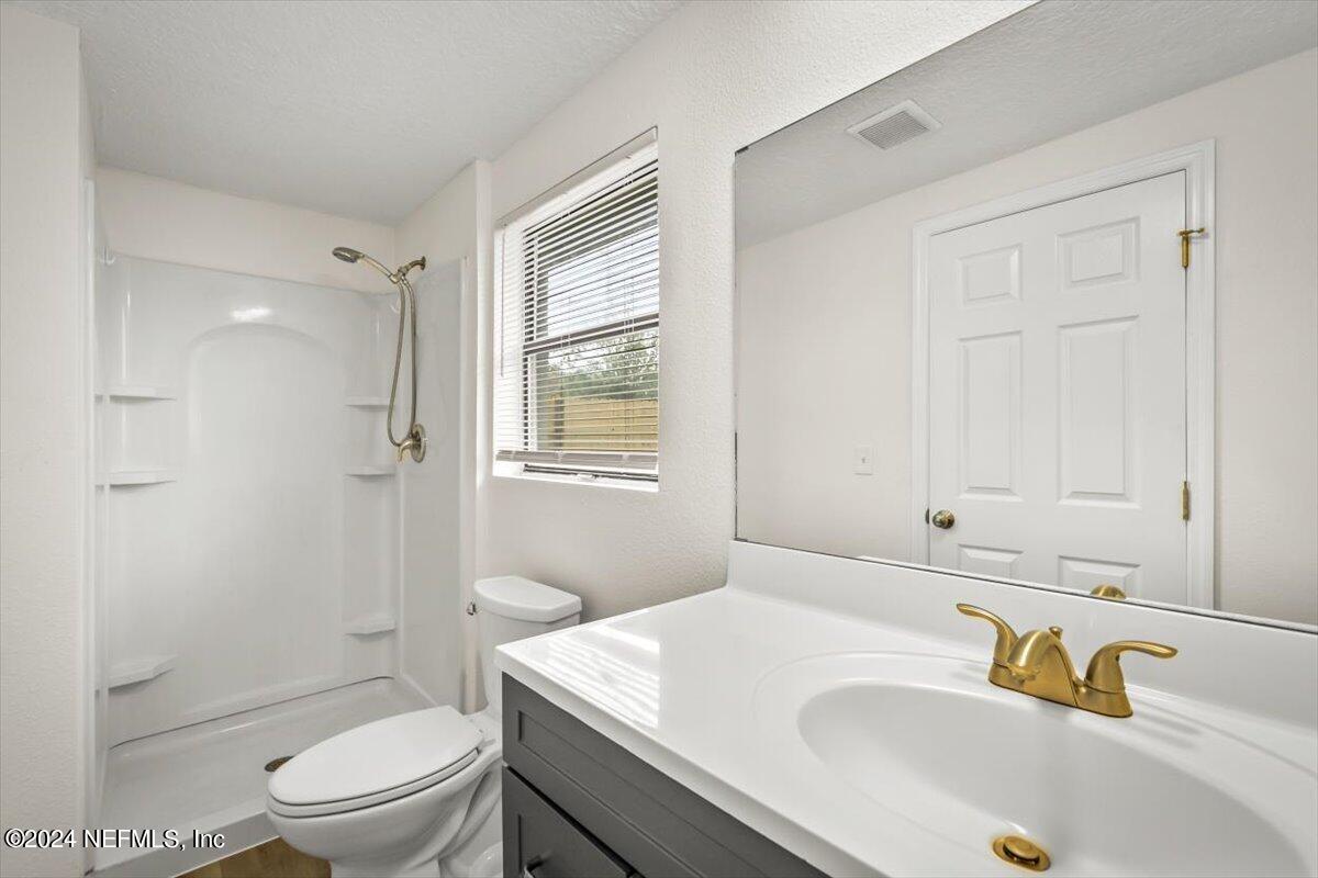 8264 Devoe Street Jacksonville, FL 32220 - Photo 18 of 24 a bathroom with a sink a toilet and shower