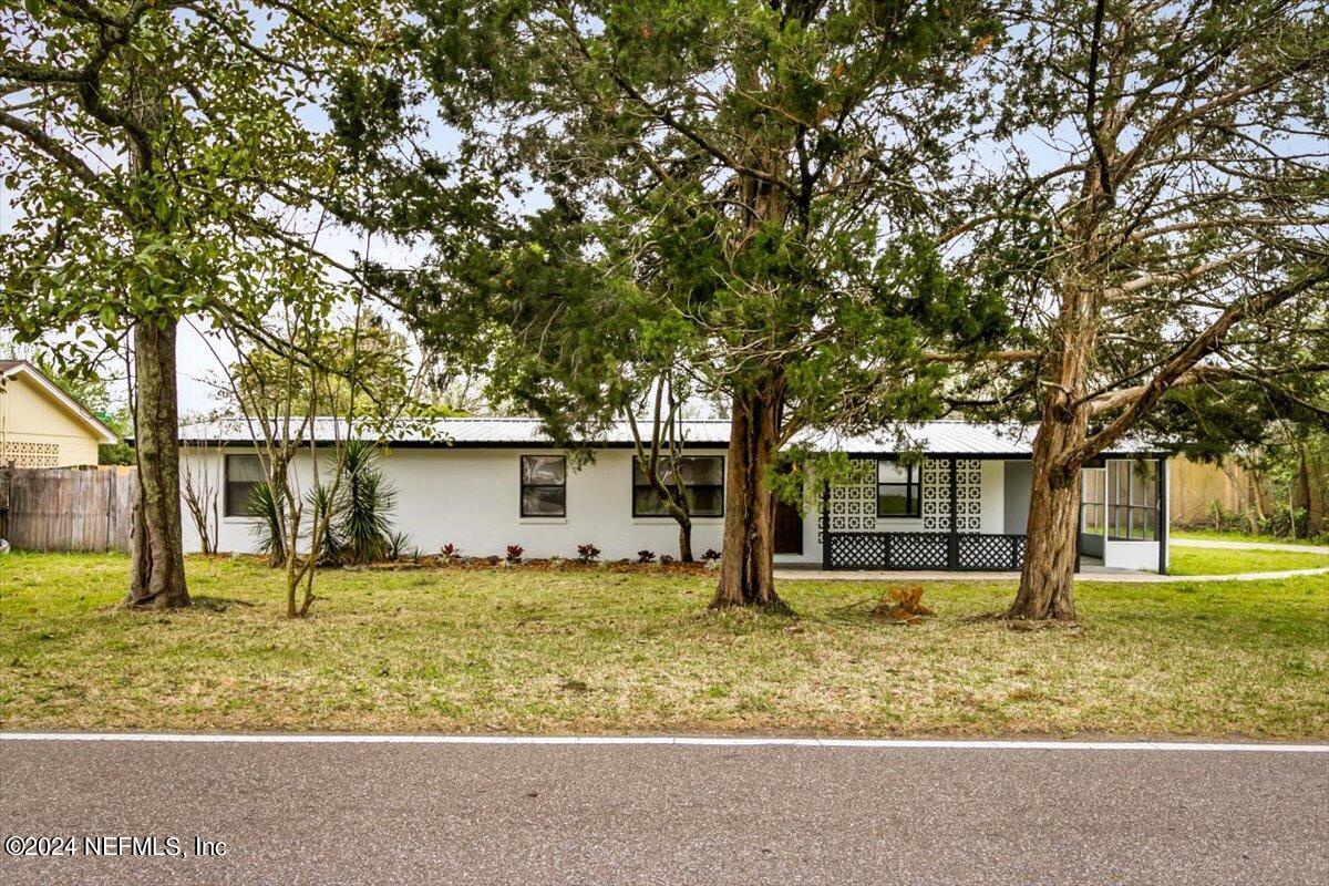 8264 Devoe Street Jacksonville, FL 32220 - Photo 20 of 24 front view of house with a yard