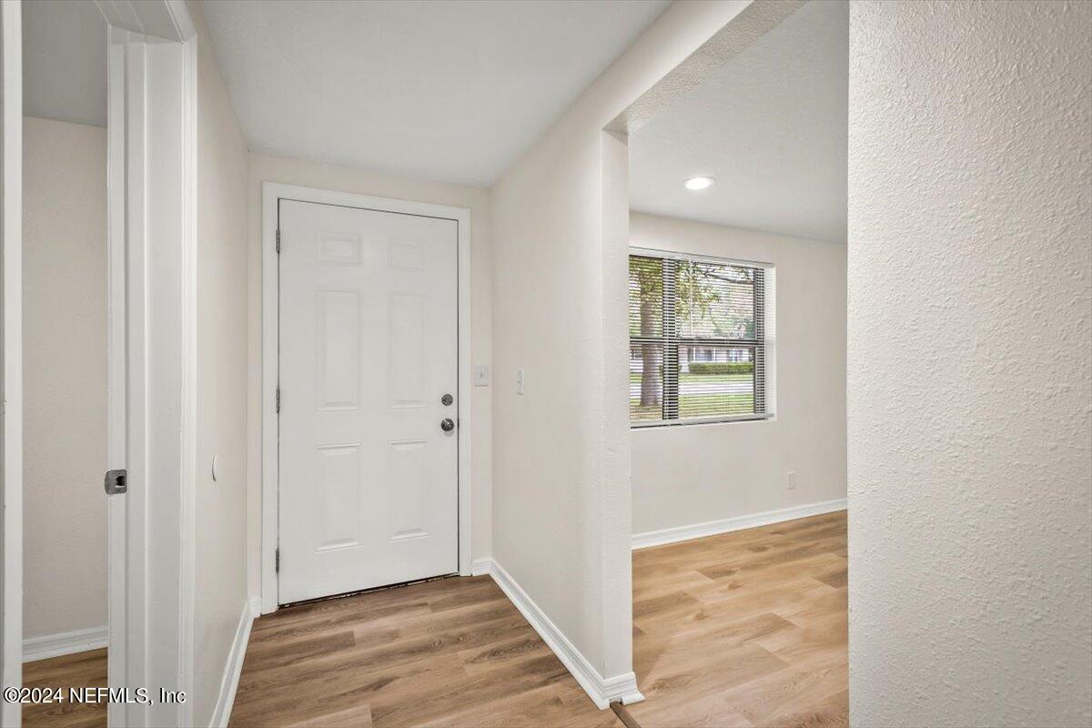 8264 Devoe Street Jacksonville, FL 32220 - Photo 2 of 24 a view of a hallway with wooden floor and closet