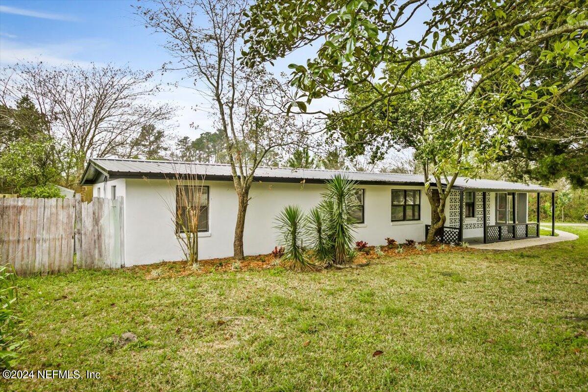8264 Devoe Street Jacksonville, FL 32220 - Photo 22 of 24 a front view of house with yard and trees