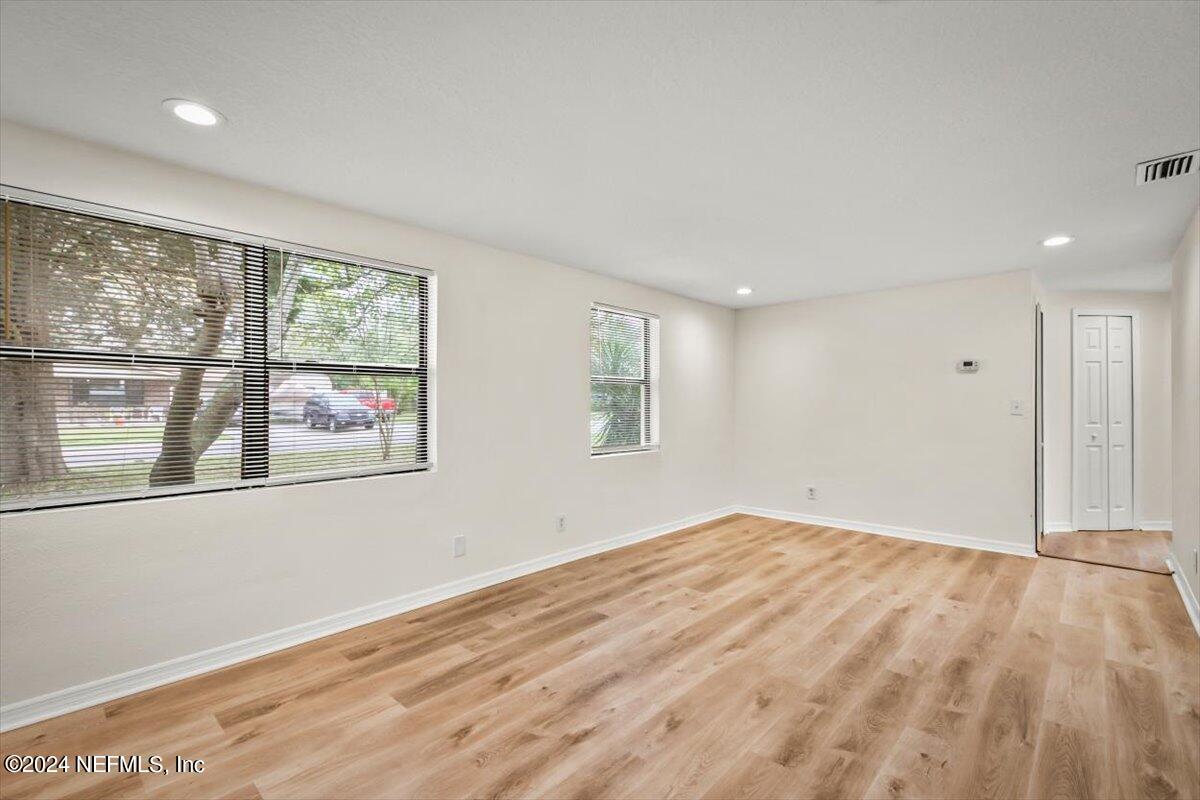 8264 Devoe Street Jacksonville, FL 32220 - Photo 3 of 24 a view of empty room with wooden floor and fan