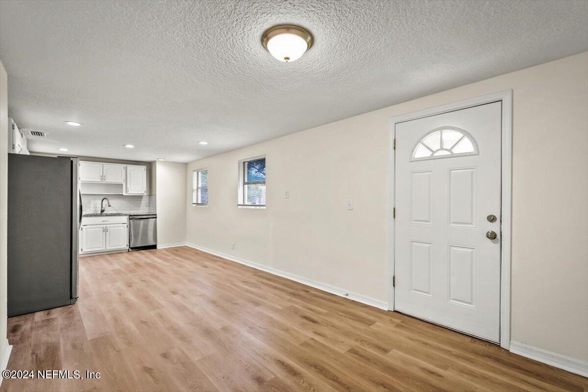 8264 Devoe Street Jacksonville, FL 32220 - Photo 6 of 24 a view of a kitchen with wooden floor and a window