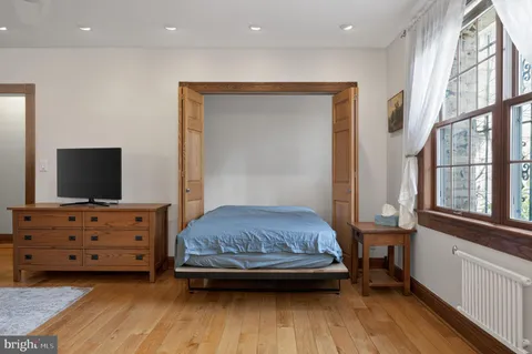 a bedroom with a bed and flat screen tv