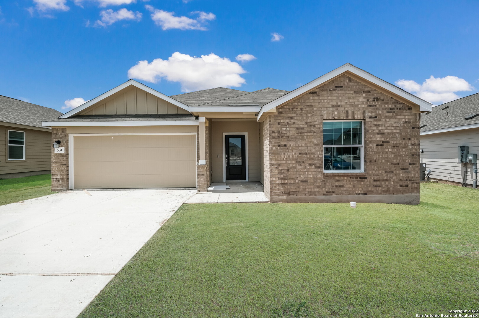 a front view of a house with a yard and garage