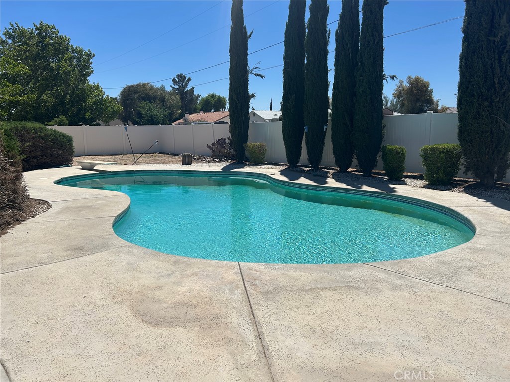 20187 Itasca Road Apple Valley, CA 92308 - Photo 28 of 35 a view of a swimming pool with a yard and sitting area