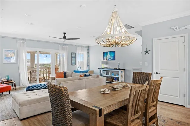 a view of a a dining room with furniture window and wooden floor