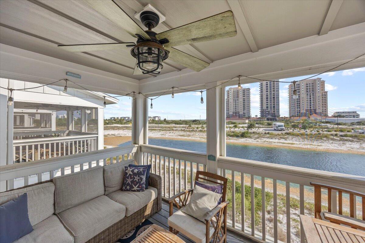 14241 Beach Heather Court Perdido Key, FL 32507 - Photo 20 of 39 a living room with furniture floor to ceiling windows and a ceiling fan