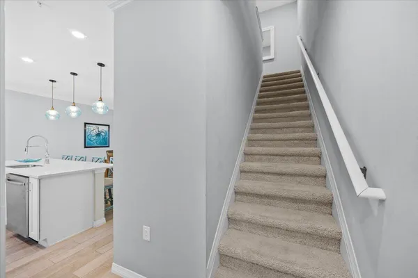 a hallway with a table and chairs