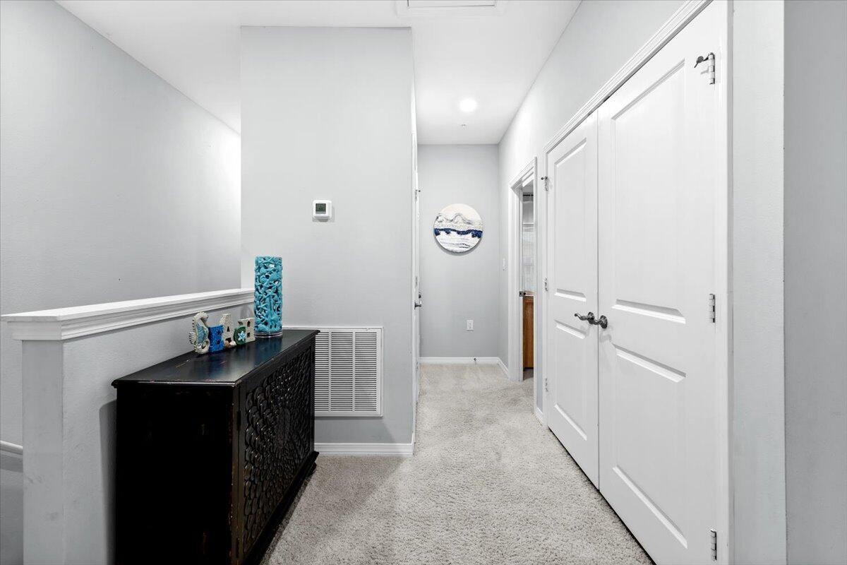 14241 Beach Heather Court Perdido Key, FL 32507 - Photo 25 of 39 a hallway with a table and chairs