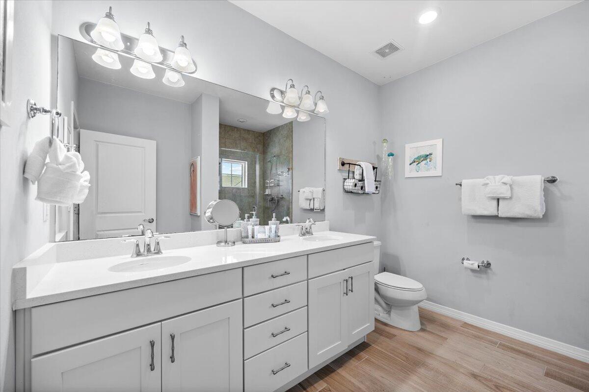14241 Beach Heather Court Perdido Key, FL 32507 - Photo 28 of 39 a bathroom with a double vanity sink mirror and toilet